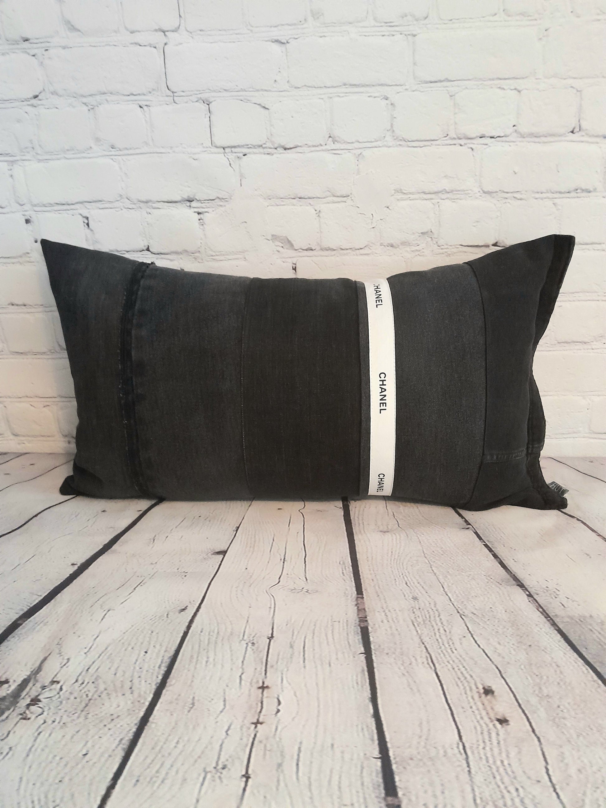 Black patchwork denim bolster cushion pillow with black and white Chanel trim.