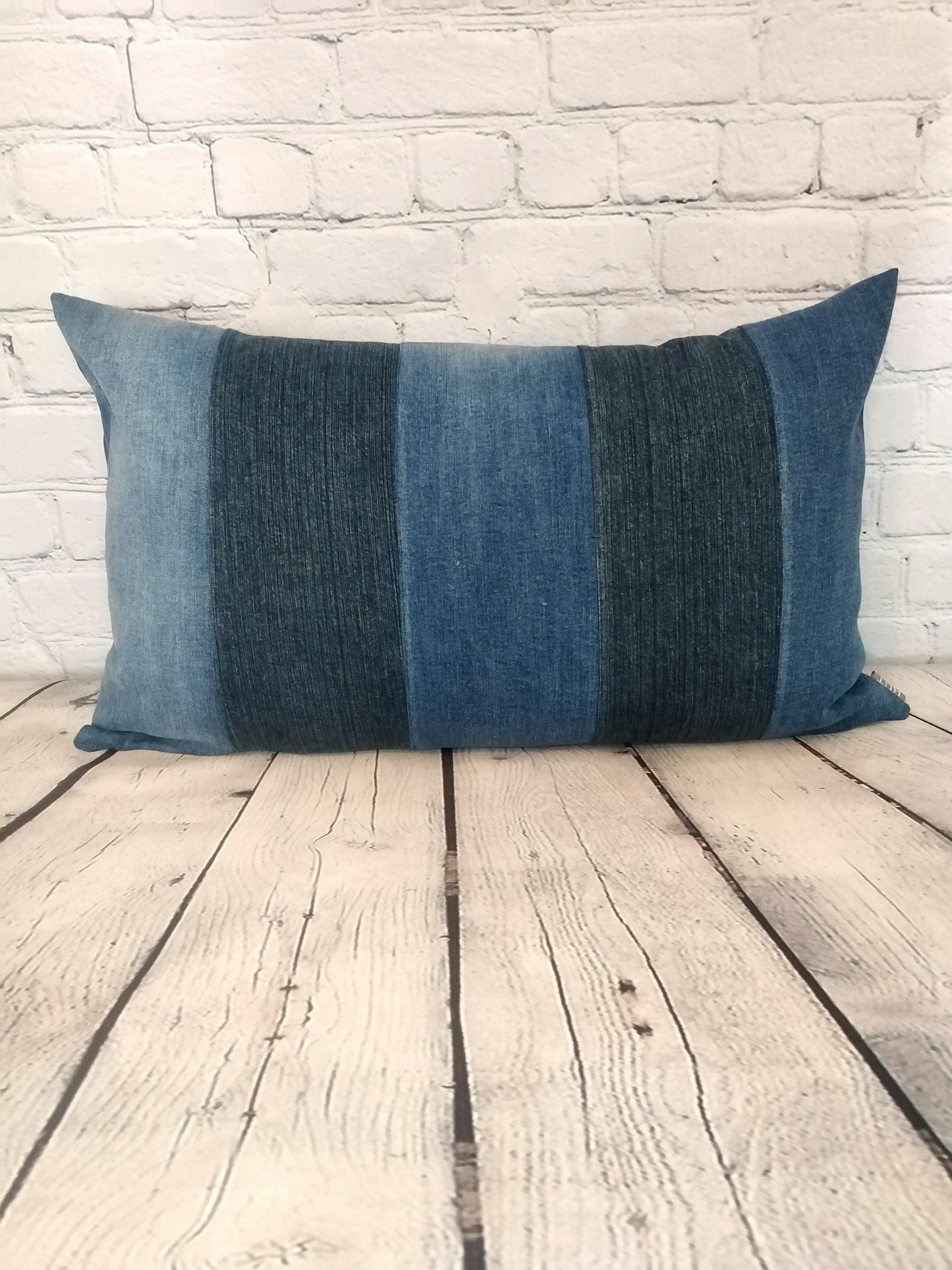 Blue denim patchwork bolster cushion, handmade in the UK.  Unique soft furnishings.