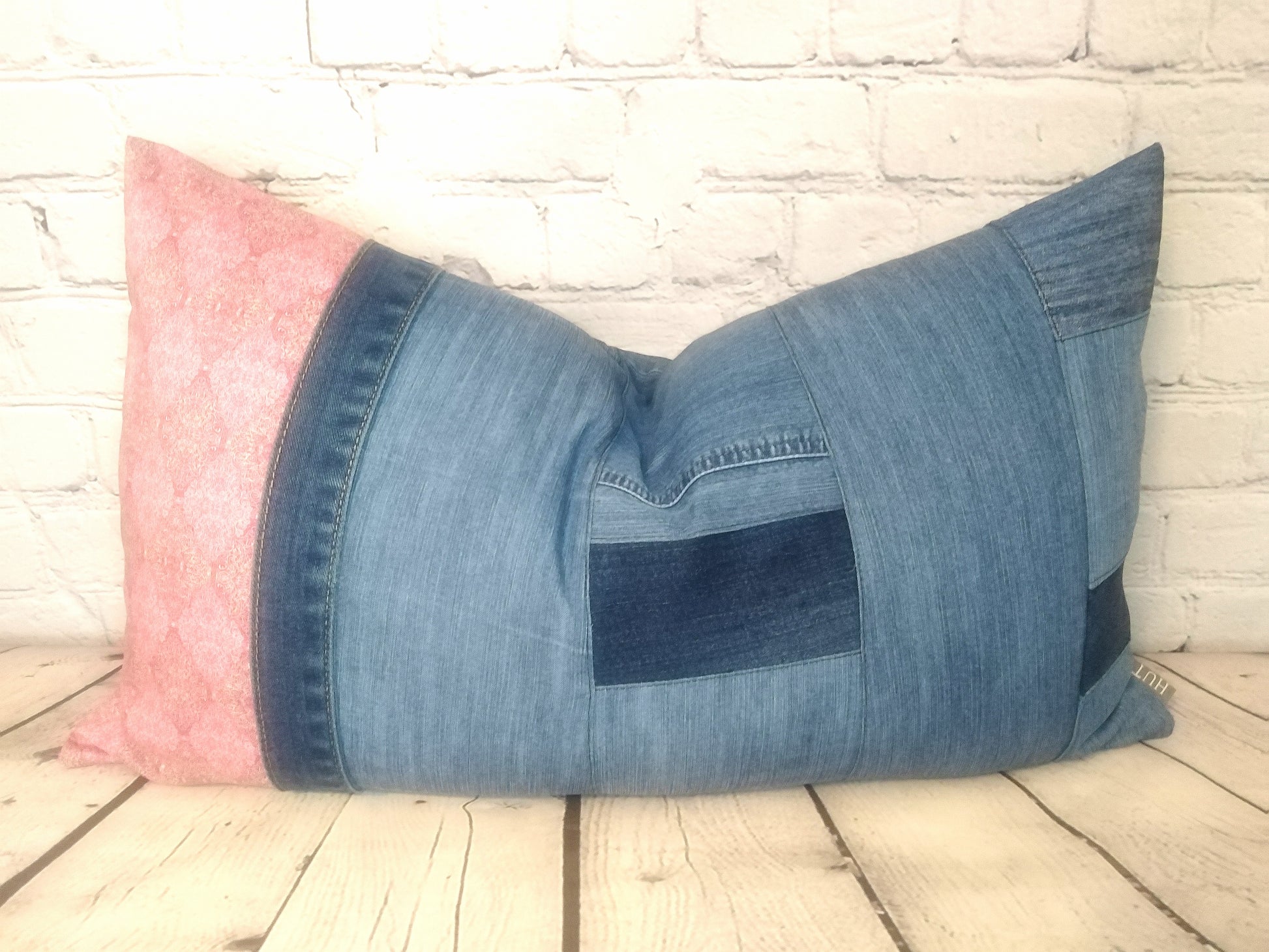 Blue vintage denim and pink Liberty Lawn fabric patchwork bolster cushion.